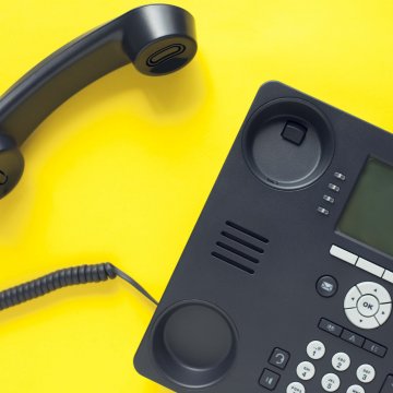 8X8 extension dialing voip service black voip phone on yellow background
